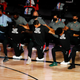 Players, coaches and staff kneel during the national anthem before the game between the Houston Rockets and the Portland Trail Blazers at The Arena at ESPN Wide World Of Sports Complex on August 04, 2020 in Lake Buena Vista, Florida.